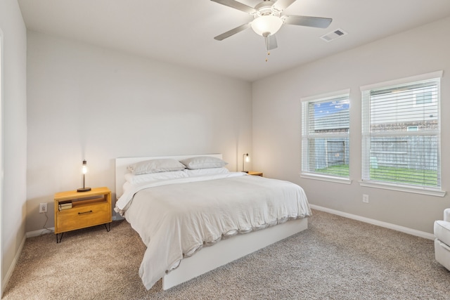 carpeted bedroom featuring ceiling fan and multiple windows