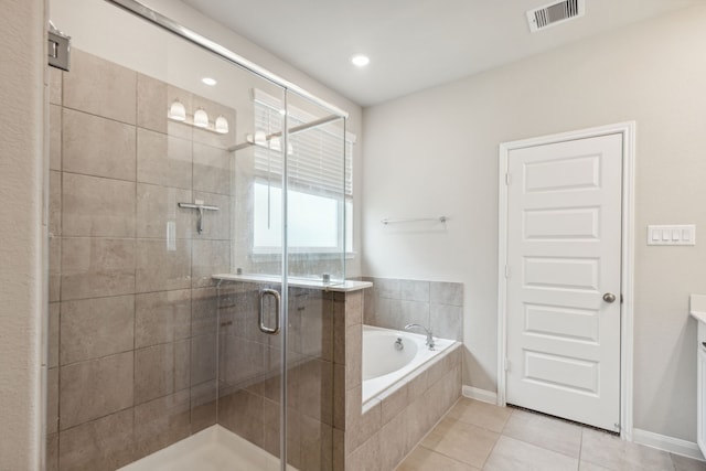 bathroom featuring plus walk in shower, vanity, and tile patterned floors