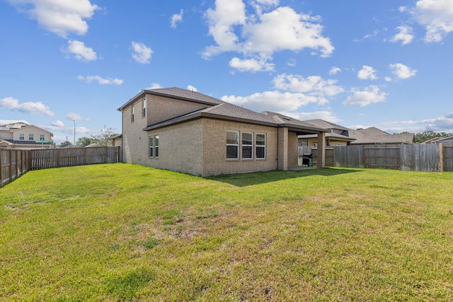 back of house featuring a lawn