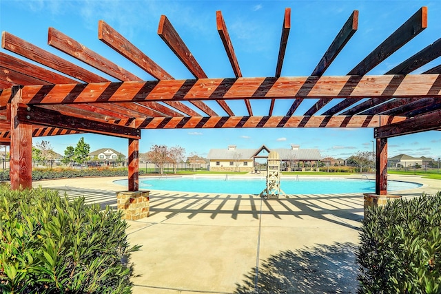 view of swimming pool featuring a patio area and a pergola