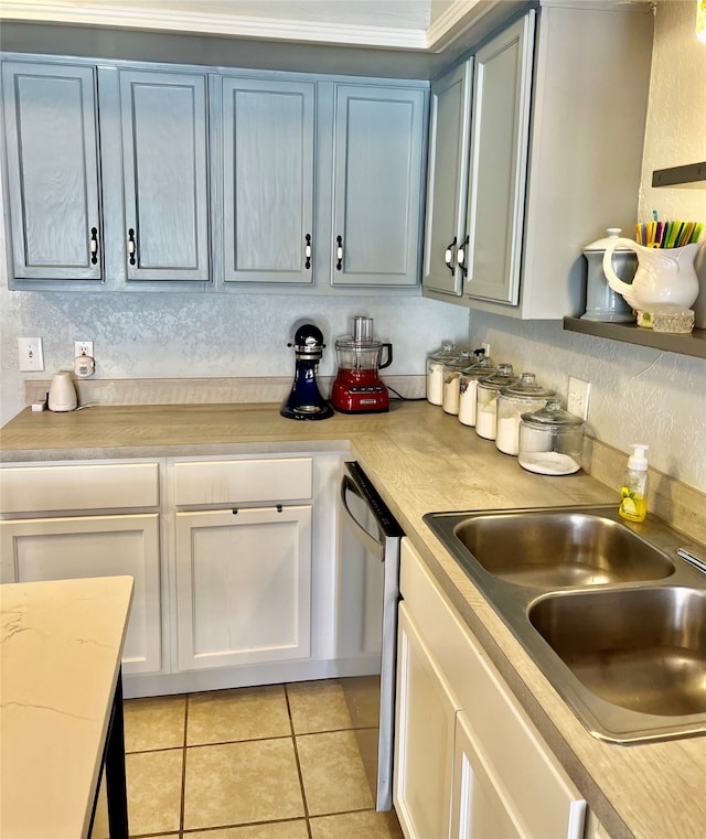 kitchen featuring light tile patterned flooring, sink, and dishwasher