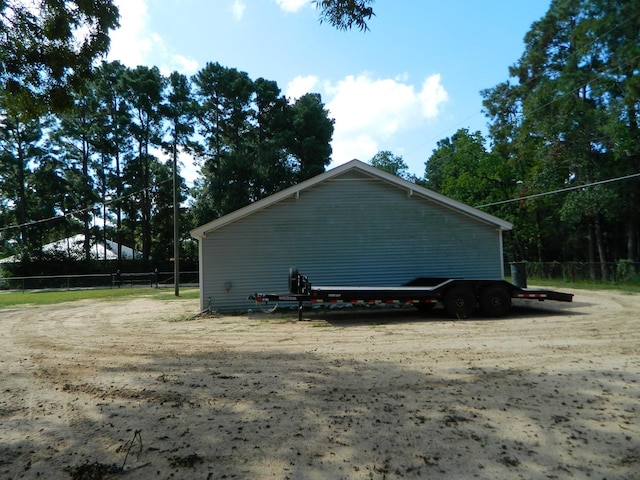 view of side of property featuring fence