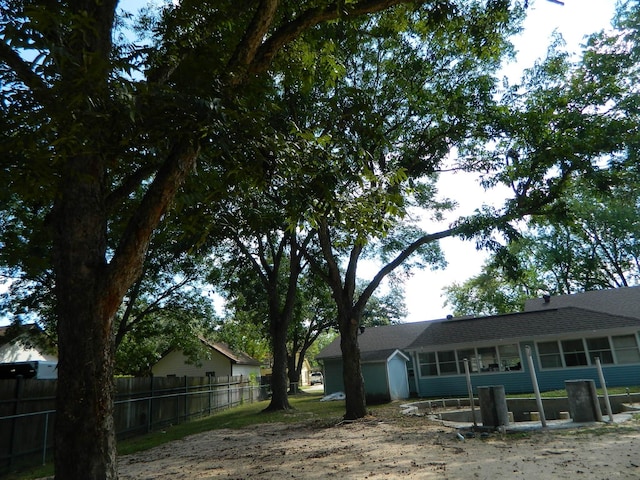 exterior space with a sunroom and fence