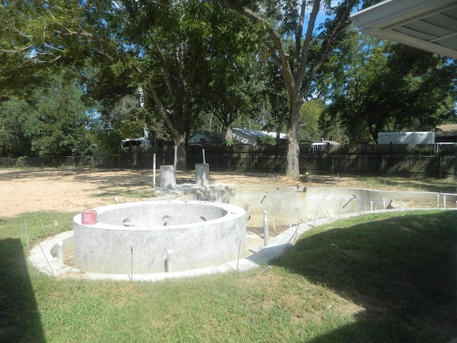 view of property's community with a yard and fence