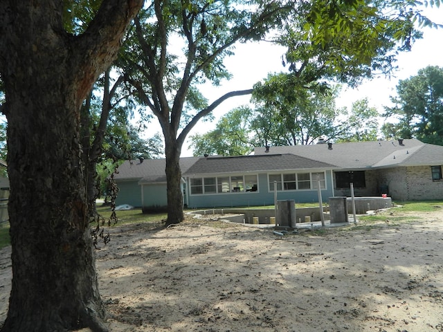 back of house featuring a sunroom