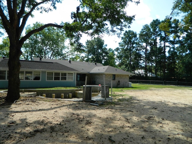 back of house featuring fence