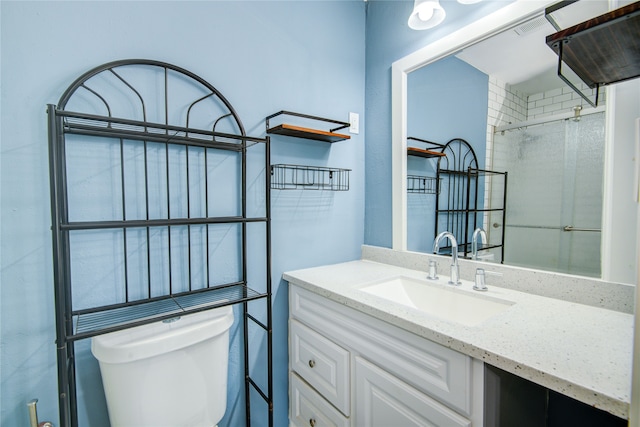 bathroom featuring vanity, toilet, and walk in shower