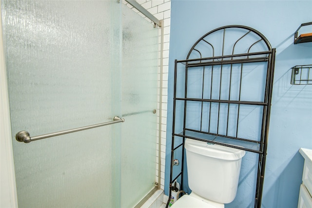 bathroom with vanity, an enclosed shower, and toilet