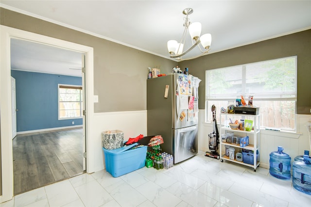 kitchen featuring hanging light fixtures, stainless steel refrigerator, and a chandelier