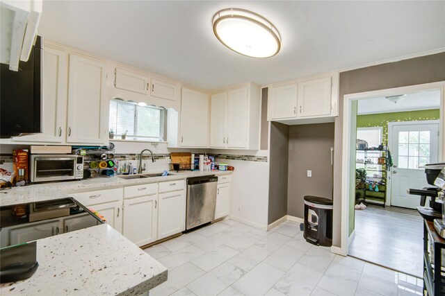 kitchen featuring dishwasher, stove, white cabinets, sink, and light stone counters