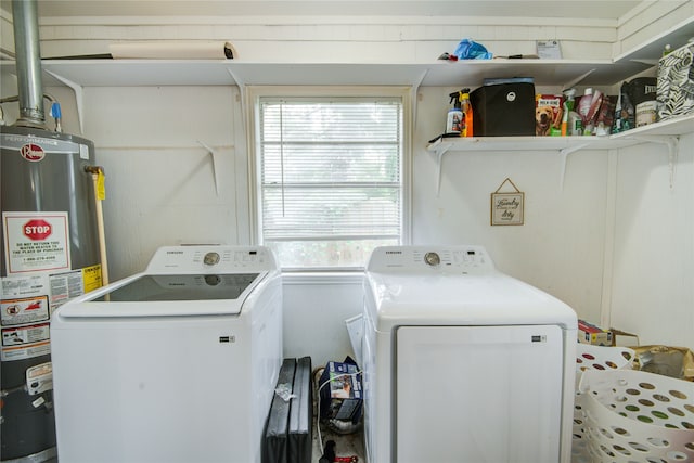 laundry area with washer and clothes dryer, a wealth of natural light, and water heater