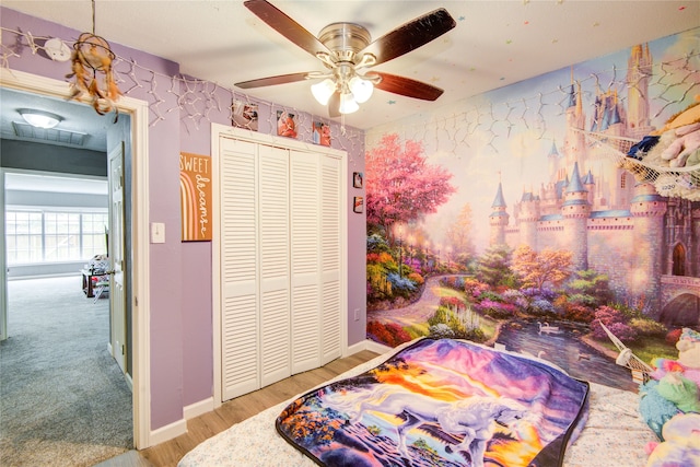 bedroom featuring ceiling fan, a closet, and light carpet