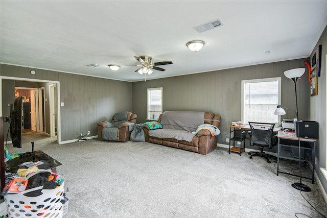 carpeted living room with ceiling fan