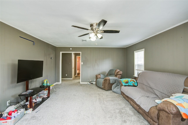 living room with light carpet, ceiling fan, and ornamental molding