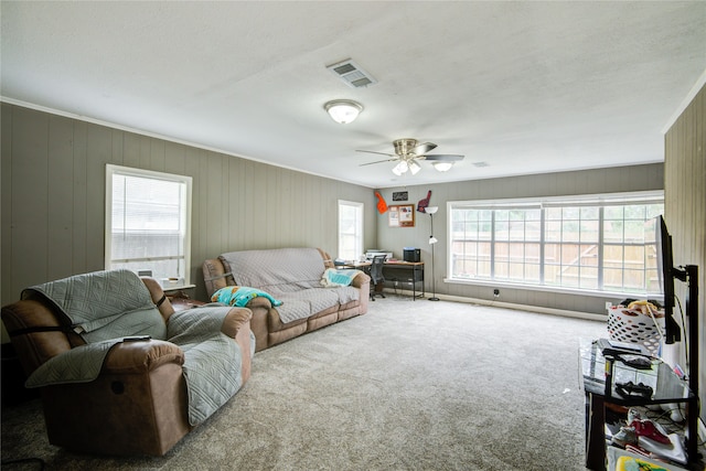 carpeted living room featuring ceiling fan