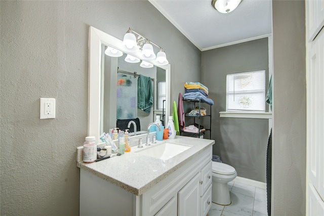 bathroom with vanity, toilet, and ornamental molding