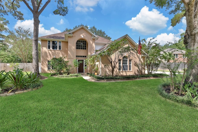 mediterranean / spanish house featuring a front lawn