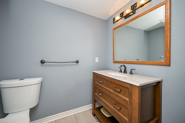 bathroom with vanity, toilet, and tile patterned flooring