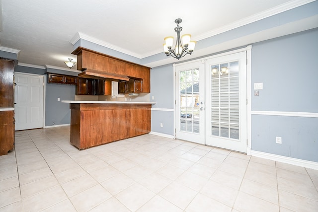 kitchen with sink, french doors, kitchen peninsula, crown molding, and an inviting chandelier