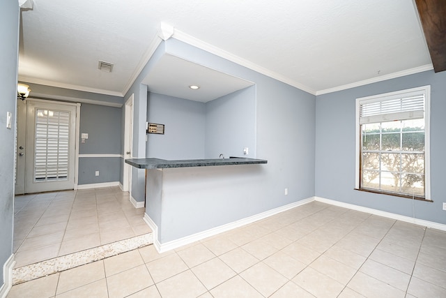 kitchen featuring a textured ceiling, ornamental molding, light tile patterned flooring, and kitchen peninsula