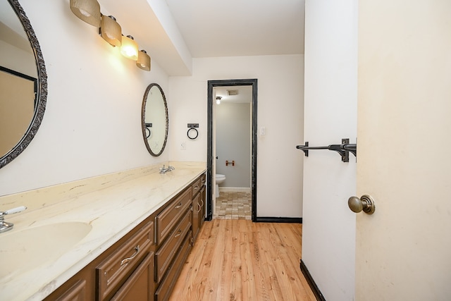 bathroom featuring vanity, toilet, and hardwood / wood-style floors