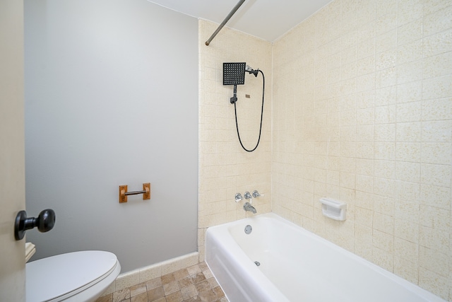 bathroom featuring toilet and tiled shower / bath combo