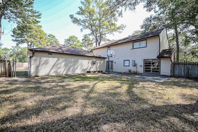 rear view of house with a patio area and a lawn