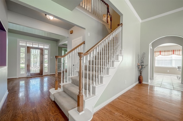 foyer featuring crown molding and hardwood / wood-style floors