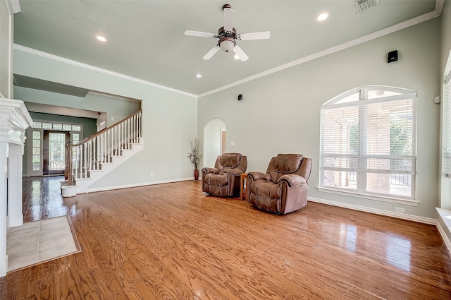 sitting room with hardwood / wood-style floors, ceiling fan, and ornamental molding