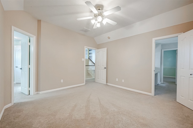 unfurnished bedroom featuring light colored carpet, ceiling fan, and lofted ceiling