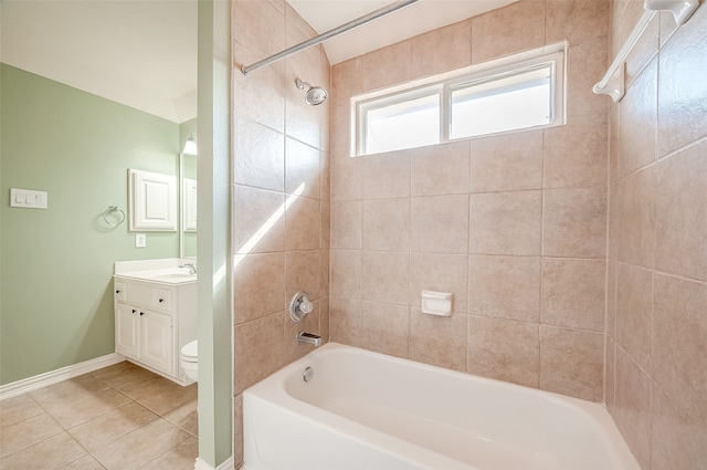 full bathroom featuring toilet, vanity, tiled shower / bath combo, and tile patterned floors