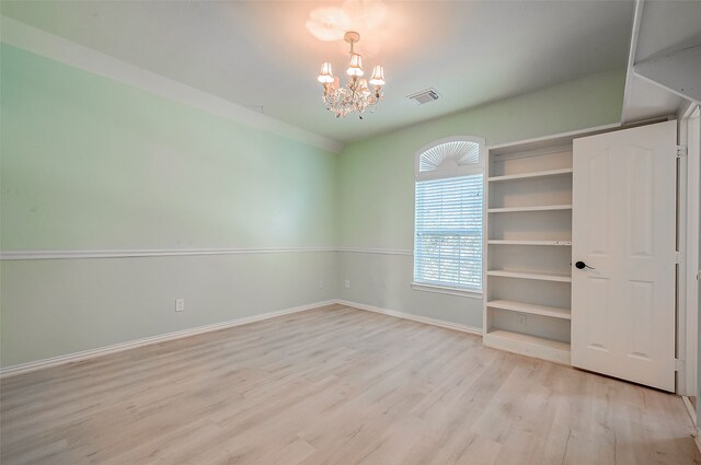 20807 Twisted Leaf Dr, Cypress, TX 77433 - unfurnished room with a chandelier, light wood-style floors, and baseboards