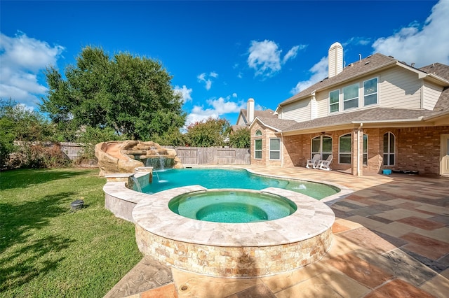 view of pool featuring an in ground hot tub, a patio, pool water feature, and a lawn