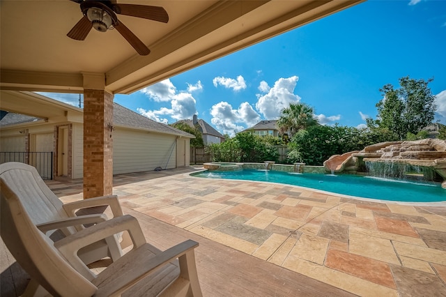 view of swimming pool with pool water feature, ceiling fan, and a patio