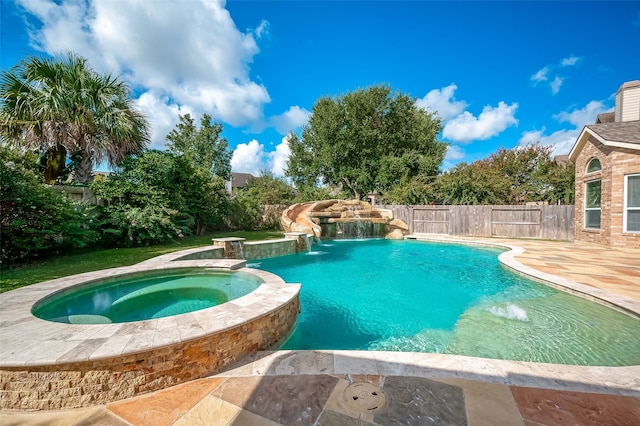 view of pool featuring pool water feature, an in ground hot tub, and a patio