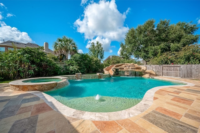 view of swimming pool featuring an in ground hot tub and pool water feature