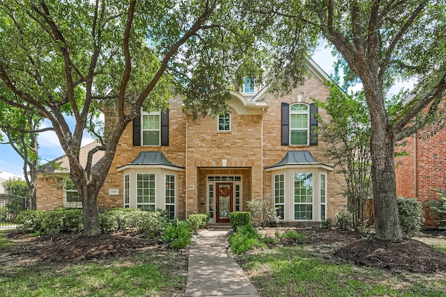 20807 Twisted Leaf Dr, Cypress, TX 77433 - traditional-style home featuring a standing seam roof, brick siding, and metal roof