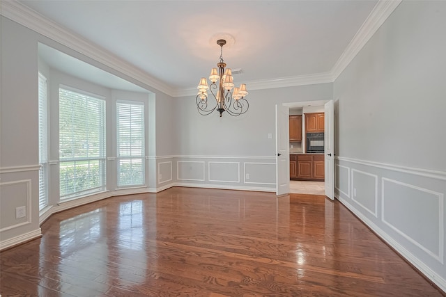20807 Twisted Leaf Dr, Cypress, TX 77433 - unfurnished room featuring a decorative wall, a chandelier, plenty of natural light, crown molding, and wood finished floors