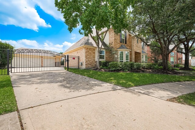 20807 Twisted Leaf Dr, Cypress, TX 77433 - view of front of house featuring a gate, brick siding, and concrete driveway