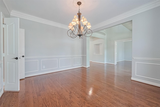 20807 Twisted Leaf Dr, Cypress, TX 77433 - unfurnished room featuring a chandelier, ornamental molding, wood finished floors, a decorative wall, and a wainscoted wall