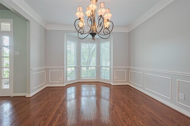 20807 Twisted Leaf Dr, Cypress, TX 77433 - unfurnished room featuring a chandelier, a decorative wall, wood finished floors, wainscoting, and ornamental molding