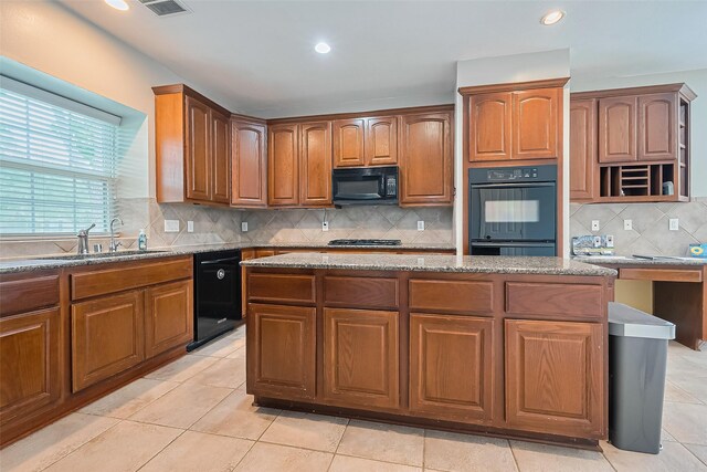 20807 Twisted Leaf Dr, Cypress, TX 77433 - kitchen with a sink, black appliances, light stone countertops, decorative backsplash, and recessed lighting