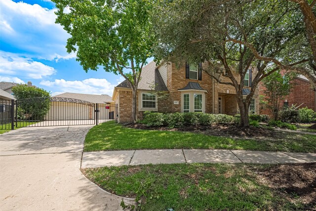 20807 Twisted Leaf Dr, Cypress, TX 77433 - traditional-style home with a gate and brick siding