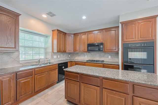 20807 Twisted Leaf Dr, Cypress, TX 77433 - kitchen with black appliances, light stone countertops, a sink, tasteful backsplash, and recessed lighting