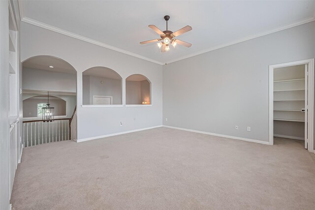 20807 Twisted Leaf Dr, Cypress, TX 77433 - empty room featuring a ceiling fan, carpet, ornamental molding, baseboards, and built in shelves