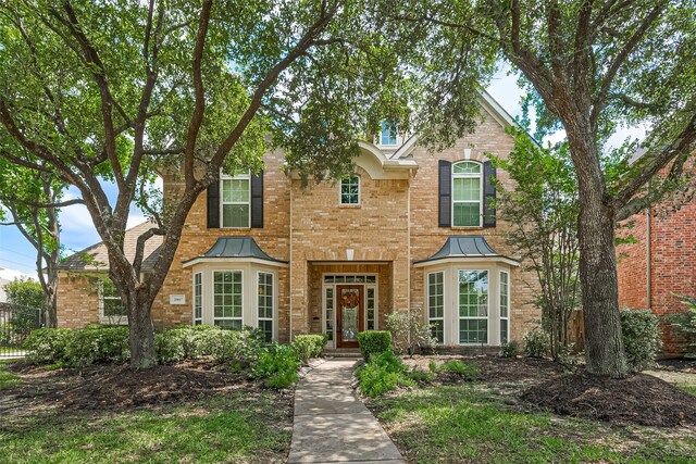 20807 Twisted Leaf Dr, Cypress, TX 77433 - traditional-style home with brick siding, a standing seam roof, and metal roof