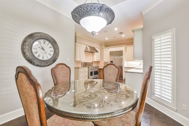 dining space featuring ornamental molding, plenty of natural light, and sink