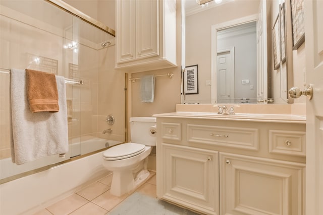 full bathroom featuring shower / bath combination with glass door, vanity, tile patterned flooring, and toilet