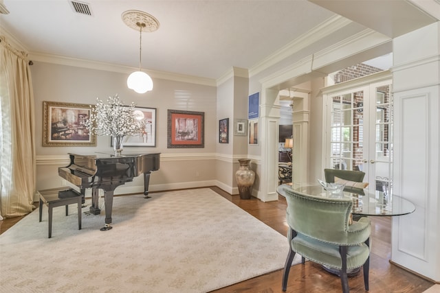 interior space with french doors, dark hardwood / wood-style floors, ornate columns, and crown molding