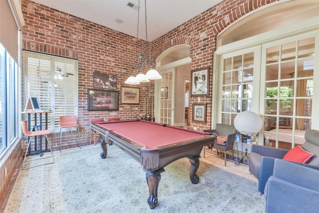 recreation room featuring pool table, french doors, and brick wall